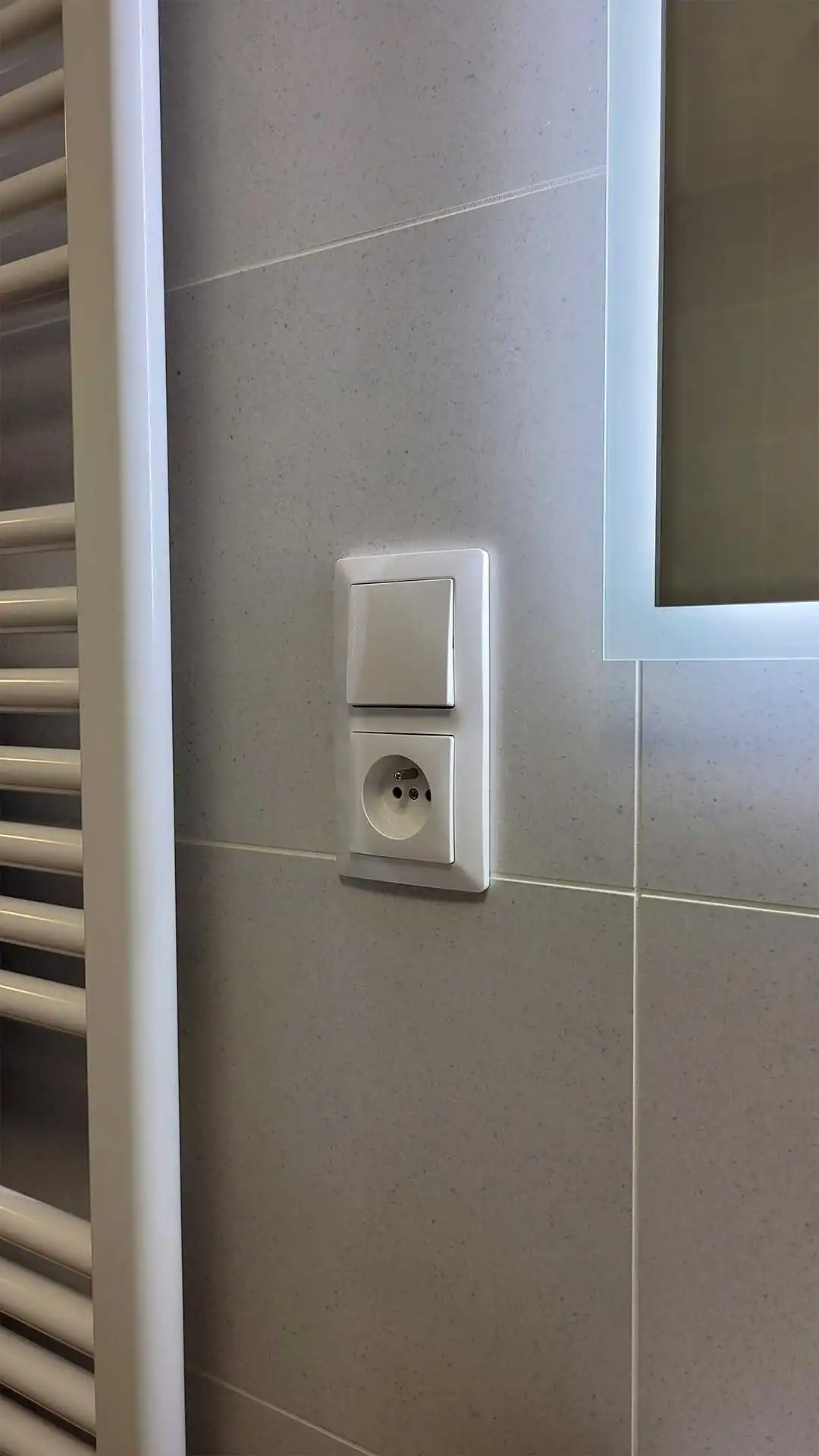 Vyp&iacute;nač a z&aacute;suvka v designu Zoni ve svisl&eacute;m dvojr&aacute;mečku v koupelně